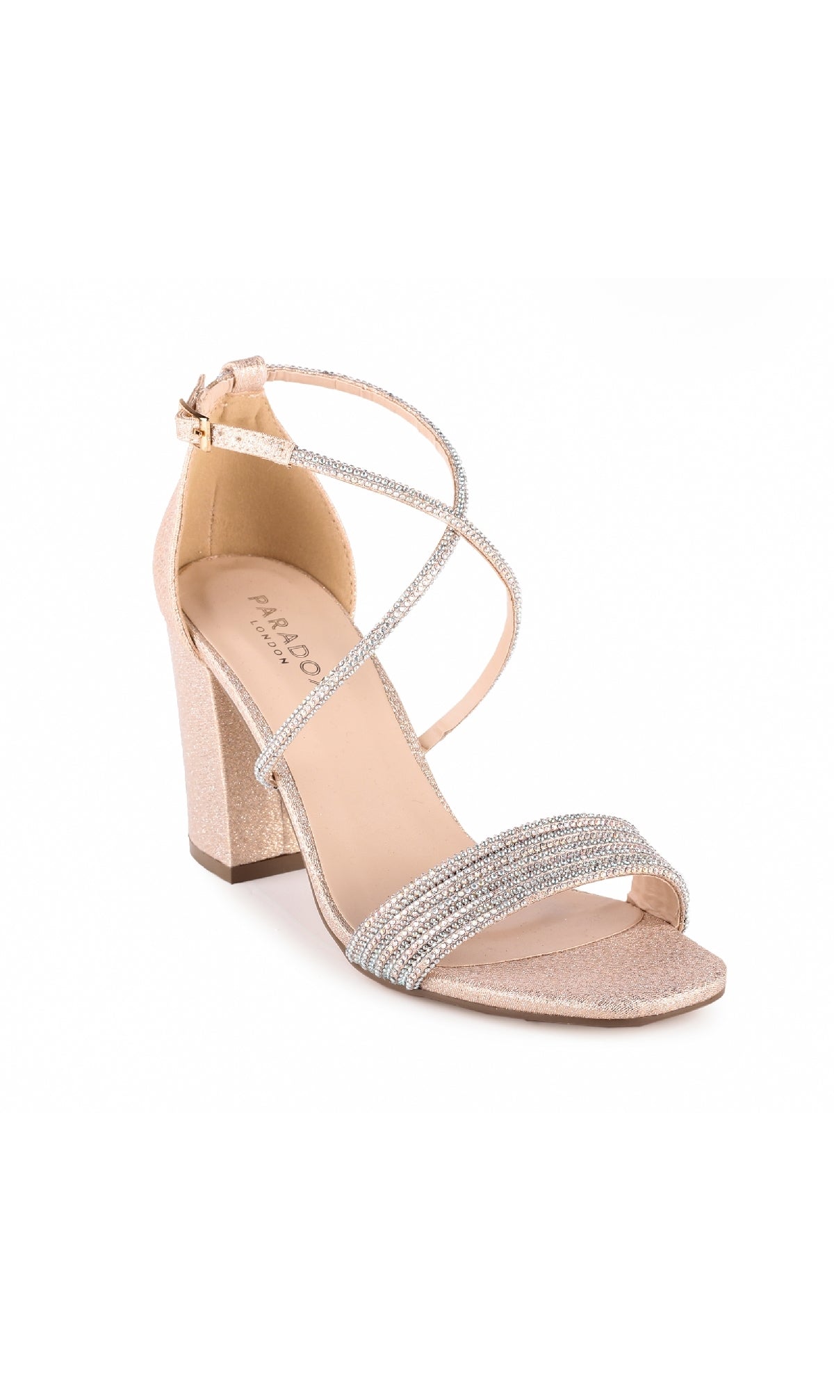 The Mackenzie Champagne Prom Shoes: Paradox London P2024 features a single nude block-heeled sandal with sparkling rhinestone straps and an ankle buckle, ideal for prom, shown on a white background.